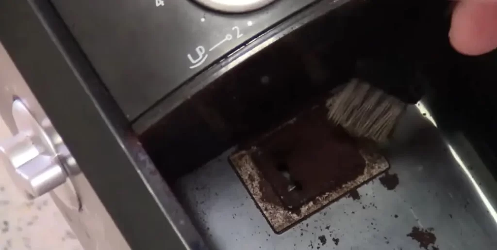 clean a Krups coffee grinder using a brush